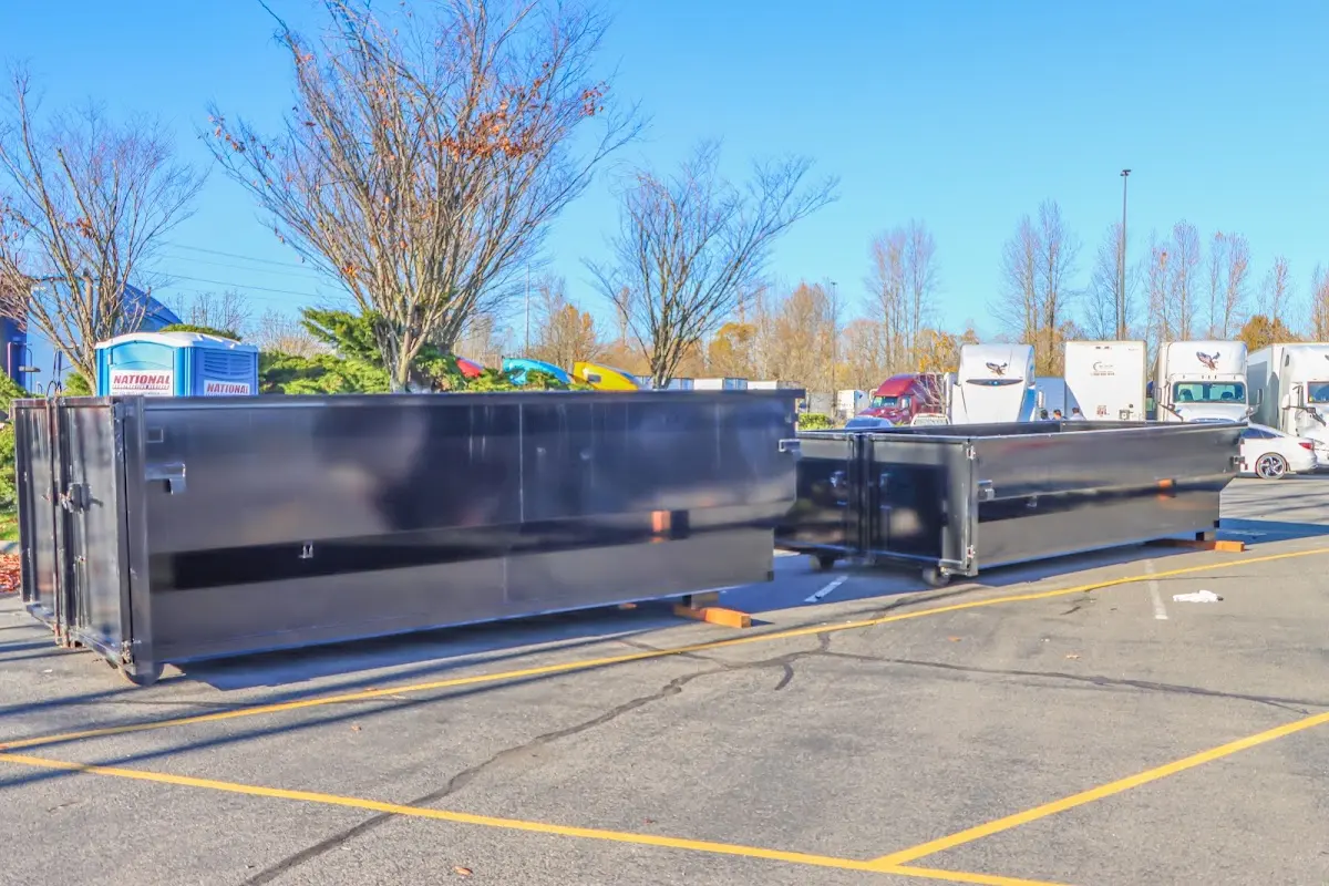 Professional dumpster rental service with roll-off container on residential driveway in Sitka